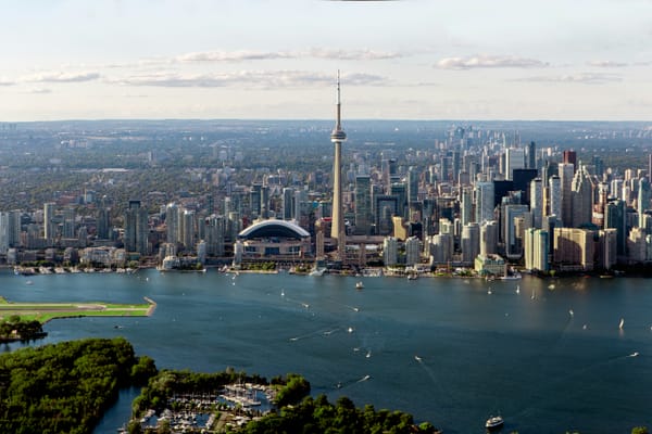 A daytime aerial shot of Toronto's skyline from Lake Ontario